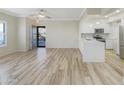 Bright open-plan living room featuring new wood floors and an adjoining kitchen at 295 N Rural Rd # 128, Chandler, AZ 85226