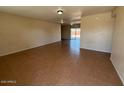 Spacious living room with tiled flooring and a sliding glass door to the backyard at 4621 N 47Th Dr, Phoenix, AZ 85031