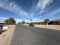 Neighborhood street view of a neighborhood with single-story homes and desert landscaping at 4621 N 47Th Dr, Phoenix, AZ 85031