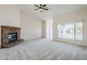 Bright living room with vaulted ceilings, fireplace and large window views at 4702 N 87Th Ave, Phoenix, AZ 85037