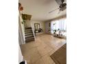 Bright living room features tile flooring, staircase, and large windows with natural light at 4845 W Marlette Ave, Glendale, AZ 85301