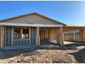 New construction home featuring a framed exterior with a covered porch and the framework for future windows at 5521 W Paseo Way, Laveen, AZ 85339