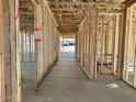 Spacious interior view displaying the framed walls and flooring of this new construction home at 5521 W Paseo Way, Laveen, AZ 85339