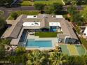 Luxury home boasts a private backyard oasis with a pool, outdoor dining, and a sports court for entertainment at 6301 E Exeter Blvd, Scottsdale, AZ 85251