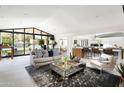 Open concept living room with stylish furnishings and view of pool at 6301 E Exeter Blvd, Scottsdale, AZ 85251