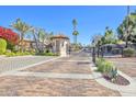 Gated community entrance featuring meticulous brick paving, lush landscaping and controlled access at 6701 N Scottsdale Rd # 23, Scottsdale, AZ 85250