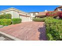 Spacious driveway leading to a two-car garage, surrounded by mature landscaping at 6701 N Scottsdale Rd # 23, Scottsdale, AZ 85250
