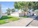 Charming home exterior with mature trees, green lawn, and a well-maintained walkway at 930 S Dobson Rd # 41, Mesa, AZ 85202