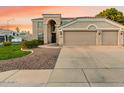 Charming two-story home with a spacious driveway and a well-maintained lawn showcasing desert landscaping at 9426 E Los Lagos Vista Ave, Mesa, AZ 85209