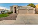 Inviting two-story home with a double garage, manicured lawn, and desert landscaping offering a welcoming entrance at 9426 E Los Lagos Vista Ave, Mesa, AZ 85209