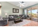 Cozy living room with comfortable seating, a ceiling fan, and a sliding glass door leading to the outdoors at 9537 E Flint Dr, Gold Canyon, AZ 85118