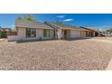 Single-story home featuring desert landscaping, a concrete driveway, and an attached garage at 1409 W Monona Dr, Phoenix, AZ 85027