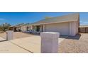 View of a single-story home with desert landscaping, a concrete driveway, and an attached garage at 1409 W Monona Dr, Phoenix, AZ 85027