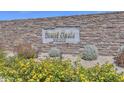 Entrance to the community with Desert Oasis at Surprise signage surrounded by stone and shrubbery at 17173 W Oberlin Way, Surprise, AZ 85387