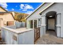 Inviting front entrance with a well-maintained courtyard, number plaque, and stylish gray-toned exterior at 1723 E Behrend Dr, Phoenix, AZ 85024