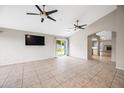 A spacious living room features tile flooring, neutral paint, high ceilings, and natural light from the sliding door at 1723 E Behrend Dr, Phoenix, AZ 85024