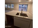 Large kitchen island with stainless steel sink and modern faucet at 18243 W Larkspur Dr, Goodyear, AZ 85338