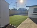 Well-maintained backyard with a patch of artificial grass, offering a clean and modern outdoor space at 1835 E Atlanta Ave, Phoenix, AZ 85040