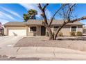 Charming single-story home featuring a low maintenance yard and attached two-car garage at 200 E Hess Ave, Coolidge, AZ 85128