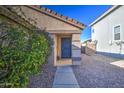 Inviting front entrance with a welcoming walkway and a view of the desert landscaping at 214 N 222Nd Dr, Buckeye, AZ 85326