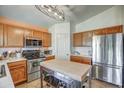 Modern kitchen featuring stainless steel appliances, a center island, and ample cabinet space at 214 N 222Nd Dr, Buckeye, AZ 85326