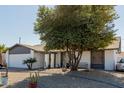 Charming single-story home featuring desert landscaping and a well-maintained front yard at 2143 W Eugie Ave, Phoenix, AZ 85029