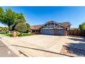 Spacious home with a wide driveway leading to a two-car garage, perfect for Gathering living at 2237 N Kachina --, Mesa, AZ 85203