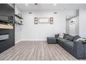 Bright living room featuring a stylish gray sofa and a sleek fireplace with floating shelves at 2246 E Sheridan St, Phoenix, AZ 85006