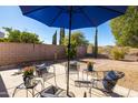 Relaxing outdoor patio with comfortable seating under a large blue umbrella at 26234 N 46Th St, Phoenix, AZ 85050