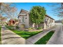 Side view of attractive gray home, landscaped yard and long paved driveway at 2861 E Camellia Dr, Gilbert, AZ 85296