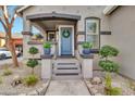 Inviting front porch with stylish blue door, decorative plants, and charming details at 2861 E Camellia Dr, Gilbert, AZ 85296