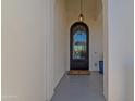 Inviting entryway featuring a decorative iron door, arched doorway, and hanging lantern at 28714 N Verde River Way, Rio Verde, AZ 85263