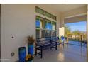 Comfortable covered patio with ample seating, potted plants, and a view of the surrounding landscape at 28714 N Verde River Way, Rio Verde, AZ 85263