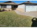 Well-manicured lawn complements this single-level home with a convenient two-car garage at 3828 W Port Au Prince Ln, Phoenix, AZ 85053