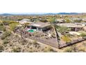 Aerial view of a home with fenced-in backyard, pool, and desert landscaping at 42429 N Cross Timbers Ct, Anthem, AZ 85086