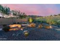 Serene backyard with desert landscaping, a cozy stone patio and mountain views at 42429 N Cross Timbers Ct, Anthem, AZ 85086