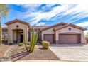 Charming single-story home featuring a well-manicured desert landscape and a spacious three-car garage at 42429 N Cross Timbers Ct, Anthem, AZ 85086