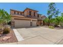 The exterior of a two-story home featuring a three-car garage, set against a bright blue sky at 4245 S 247Th Dr, Buckeye, AZ 85326