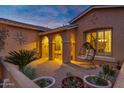 Charming front porch with a hanging chair and decorative archways, perfect for relaxing outdoors at 42975 W Misty Morning Ln, Maricopa, AZ 85138