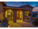 Inviting front entrance with a covered porch, decorative wreath, and cozy seating area at 42975 W Misty Morning Ln, Maricopa, AZ 85138