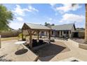 Expansive backyard with a covered patio, pergola, and plenty of space for outdoor activities at 45 S Rita Ln, Chandler, AZ 85226