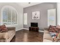 Comfortable living room featuring hardwood floors, neutral paint and bright white shuttered windows at 4529 S Granite St, Gilbert, AZ 85297