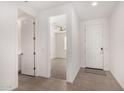 Bright entryway with tile flooring, leading to a bedroom and featuring a white front door at 4642 W Suncup Dr, San Tan Valley, AZ 85144