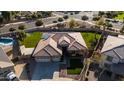 An aerial view of a house showcasing its landscaped front yard, brown roof, and modern architectural style at 4702 N 151St Dr, Goodyear, AZ 85395