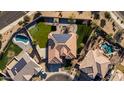 Aerial perspective of a modern home with a tiled roof and a landscaped backyard with a charming gazebo at 4702 N 151St Dr, Goodyear, AZ 85395