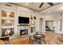 Bright living room with stone fireplace, built-in shelving, and neutral tones, offering a cozy and elegant atmosphere at 6998 E Soaring Eagle Way, Scottsdale, AZ 85266