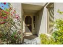 Charming covered front entrance featuring security door and desert landscaping at 7016 E Stone Raven Trl, Scottsdale, AZ 85266