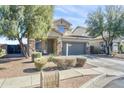 Charming two-story home with meticulously landscaped front yard at 7703 S 68Th Dr, Laveen, AZ 85339