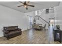 Open-concept living room featuring a staircase and elegant chandelier at 7703 S 68Th Dr, Laveen, AZ 85339