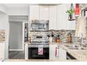 Stylish kitchen features white cabinets, granite countertops, and stainless steel appliances at 8231 N 21St Dr # E101, Phoenix, AZ 85021